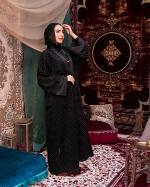Black Samaa Kaftan by THT GIRL featuring flowing fabric and intricate design, perfect for elegant fashion occasions.