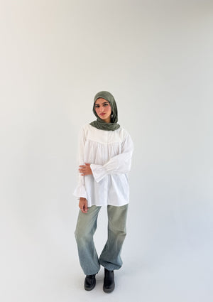 White Lady blouse by THT GIRL displayed on a hanger with detailed fabric and stylish collar, perfect for casual or formal wear.