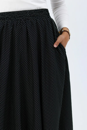 Black Riviera THT GIRL blouse with stylish design, displayed on a hanger against a neutral background.