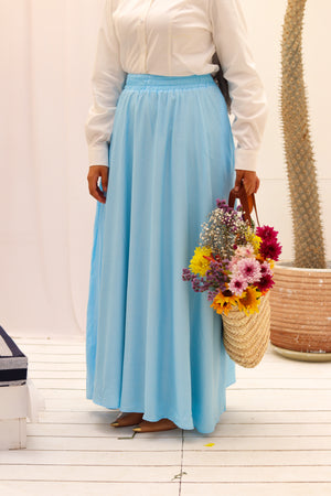 THT GIRL baby blue Riviera skirt paired with a matching blouse, displayed on a hanger.