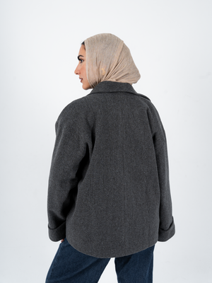 THT GIRL Tokyo Oversized Grey Jacket displayed on a hanger, showcasing its relaxed fit and modern fashion style.