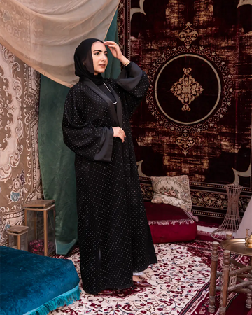 Black Samaa Kaftan by THT GIRL featuring flowing fabric and intricate design, perfect for elegant fashion occasions.