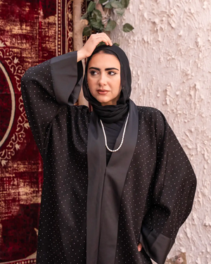 Black Samaa Kaftan by THT GIRL featuring flowing fabric and intricate detailing, perfect for stylish fashion statements.