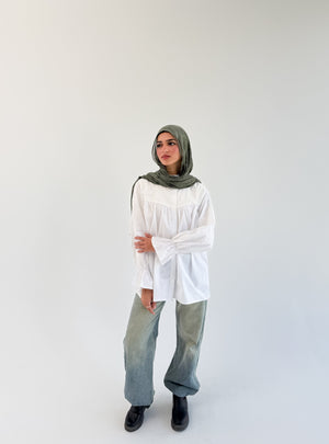 White Lady Blouse by THT GIRL, featuring a stylish, lightweight fabric and classic design, displayed on a hanger.