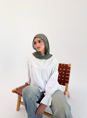White Lady Blouse by THT GIRL displayed on a hanger, showing the classic design and lightweight fabric of the stylish women's top.