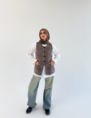 THT GIRL London Burgundy Check Vest displayed on a hanger, featuring a classic check pattern and tailored fit.