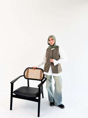 Olive check London vest by THT GIRL displayed on a hanger, featuring a stylish check pattern and tailored fit.