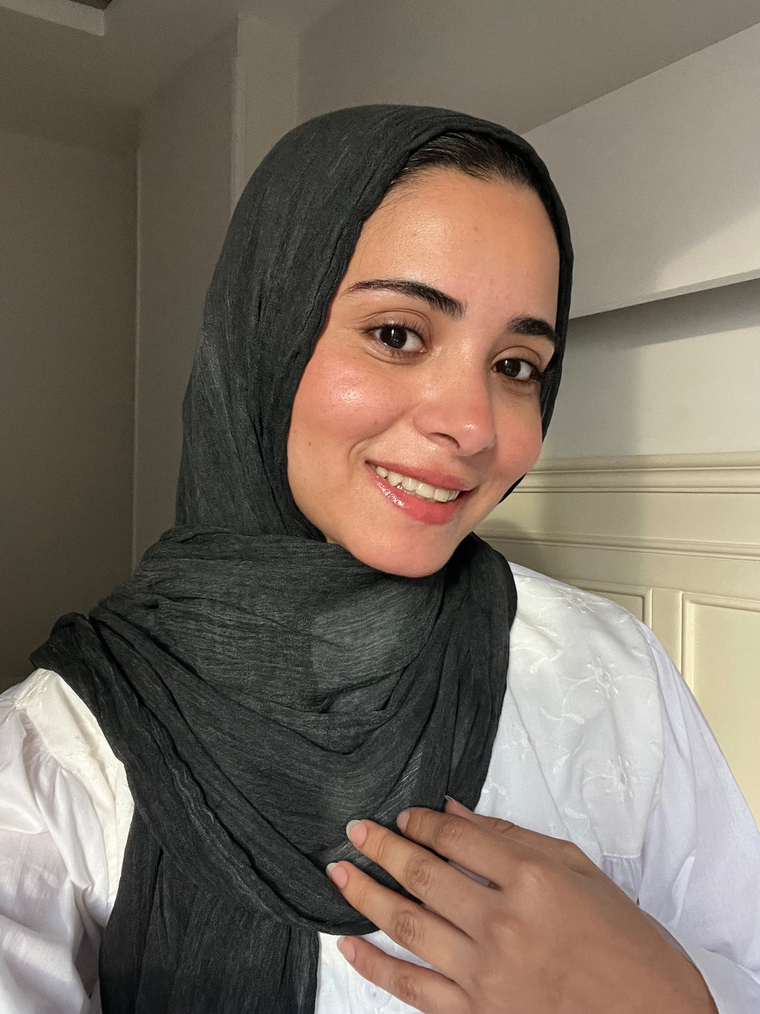 Charcoal gray Ready To Go hijab by THT GIRL displayed on a hanger, showcasing its soft, comfortable fabric and versatile style.