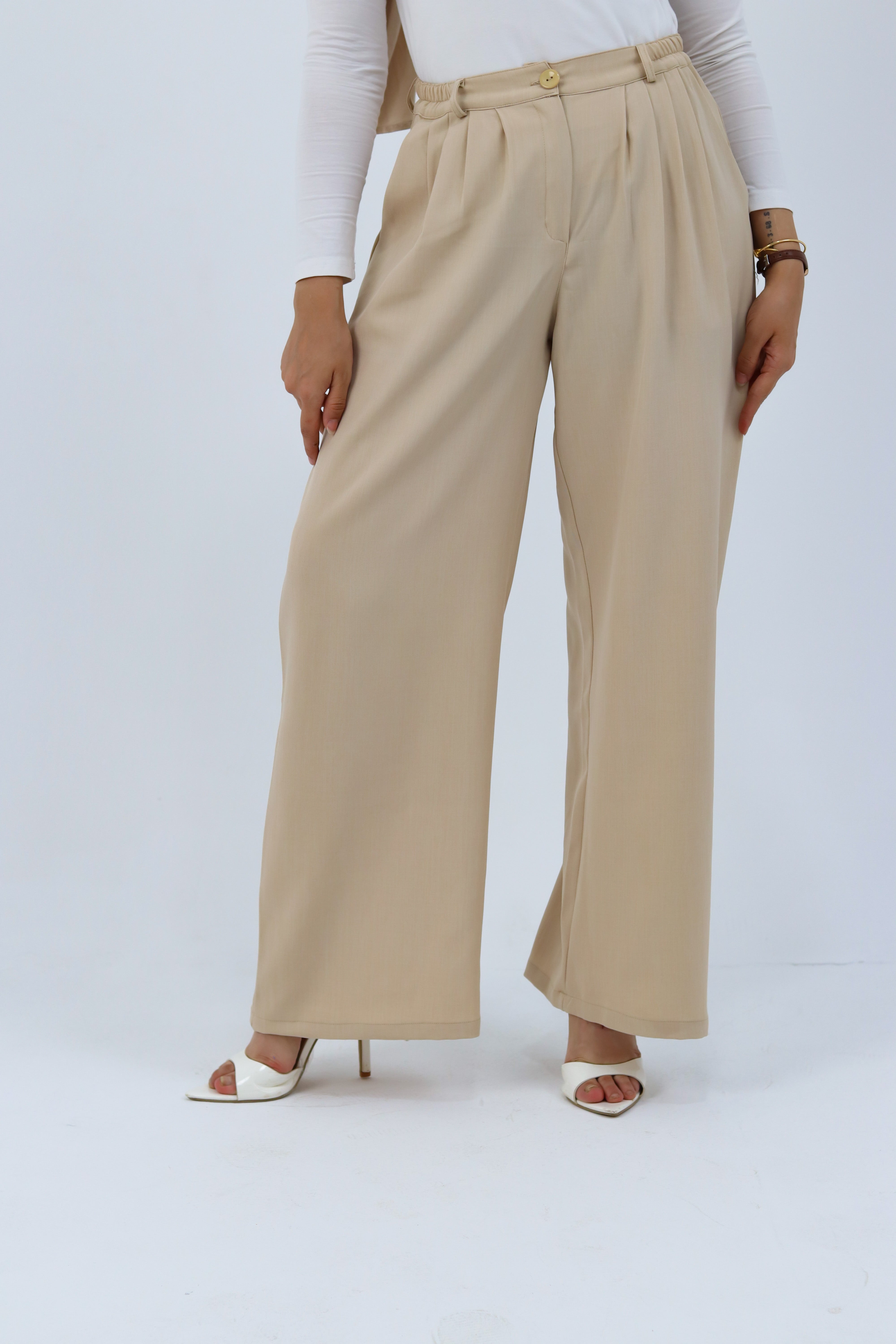 Beige loose pants by THT GIRL, featuring a relaxed fit with soft fabric and casual style, displayed on a hanger.