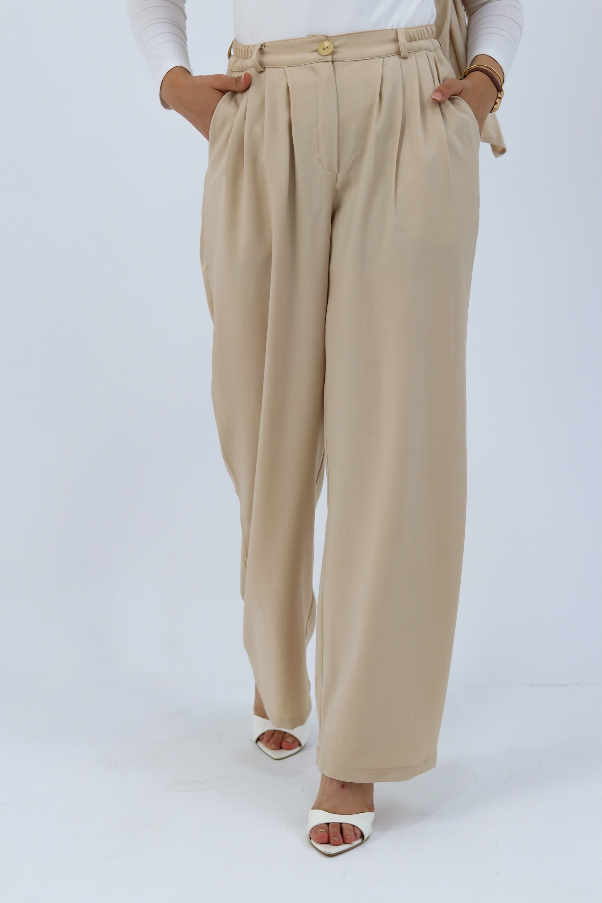 Beige loose pants by THT GIRL displayed on a hanger with a relaxed fit and soft fabric, perfect for casual wear.