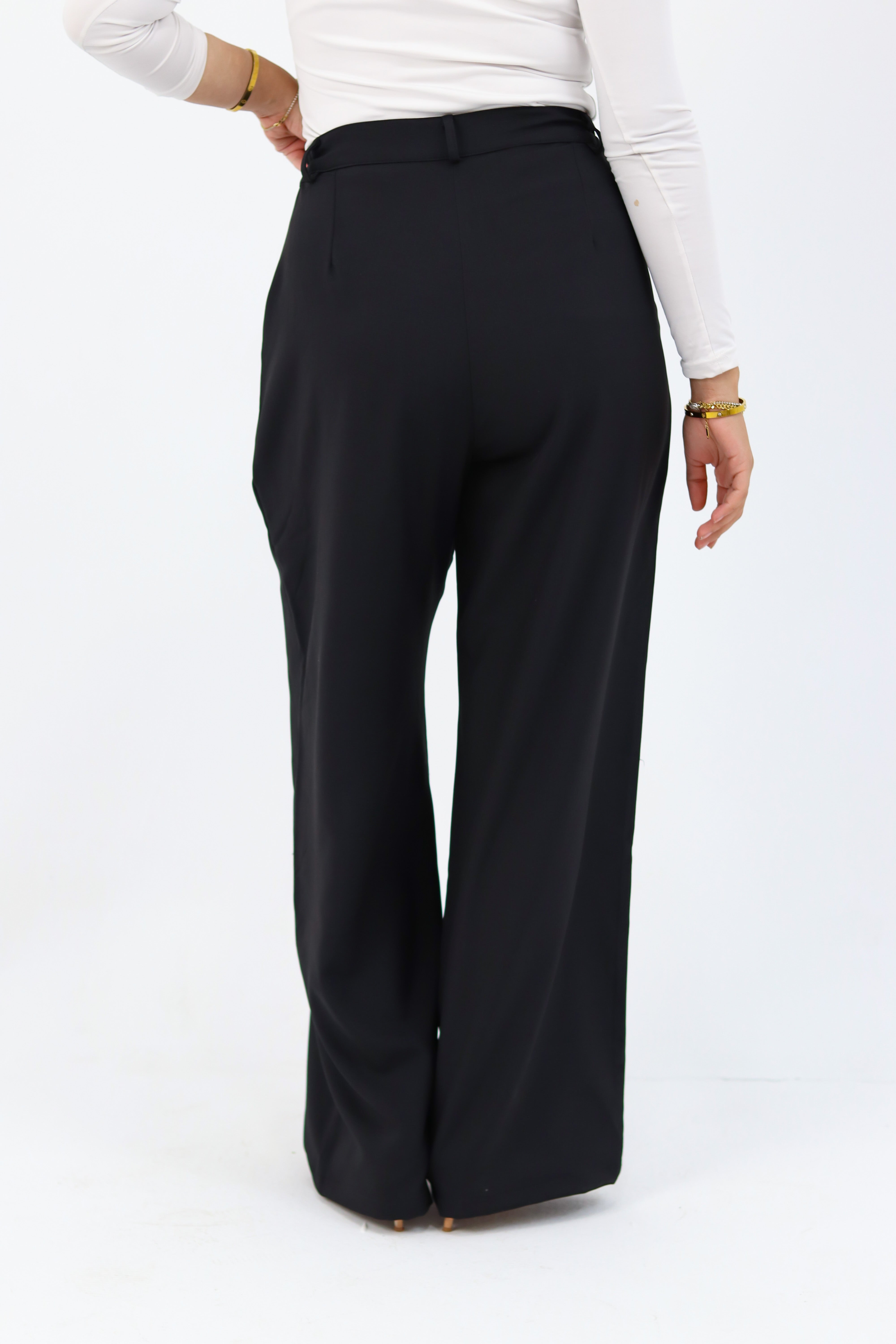Black loose pants by THT GIRL displayed on a model, showing relaxed fit and casual style.