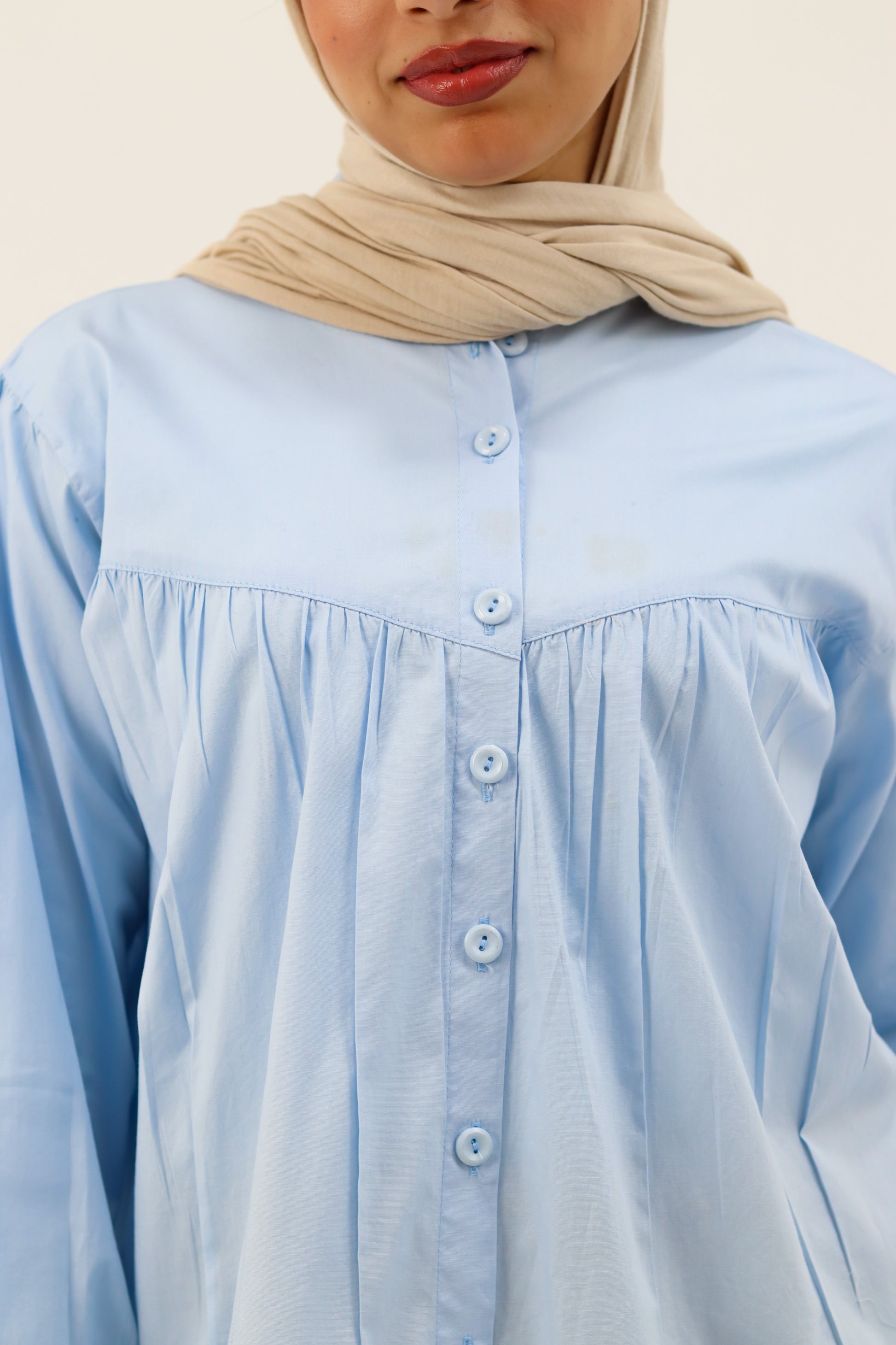 Baby blue THT GIRL Lady Blouse displayed on a hanger, showcasing lightweight fabric and classic design for casual or office wear.