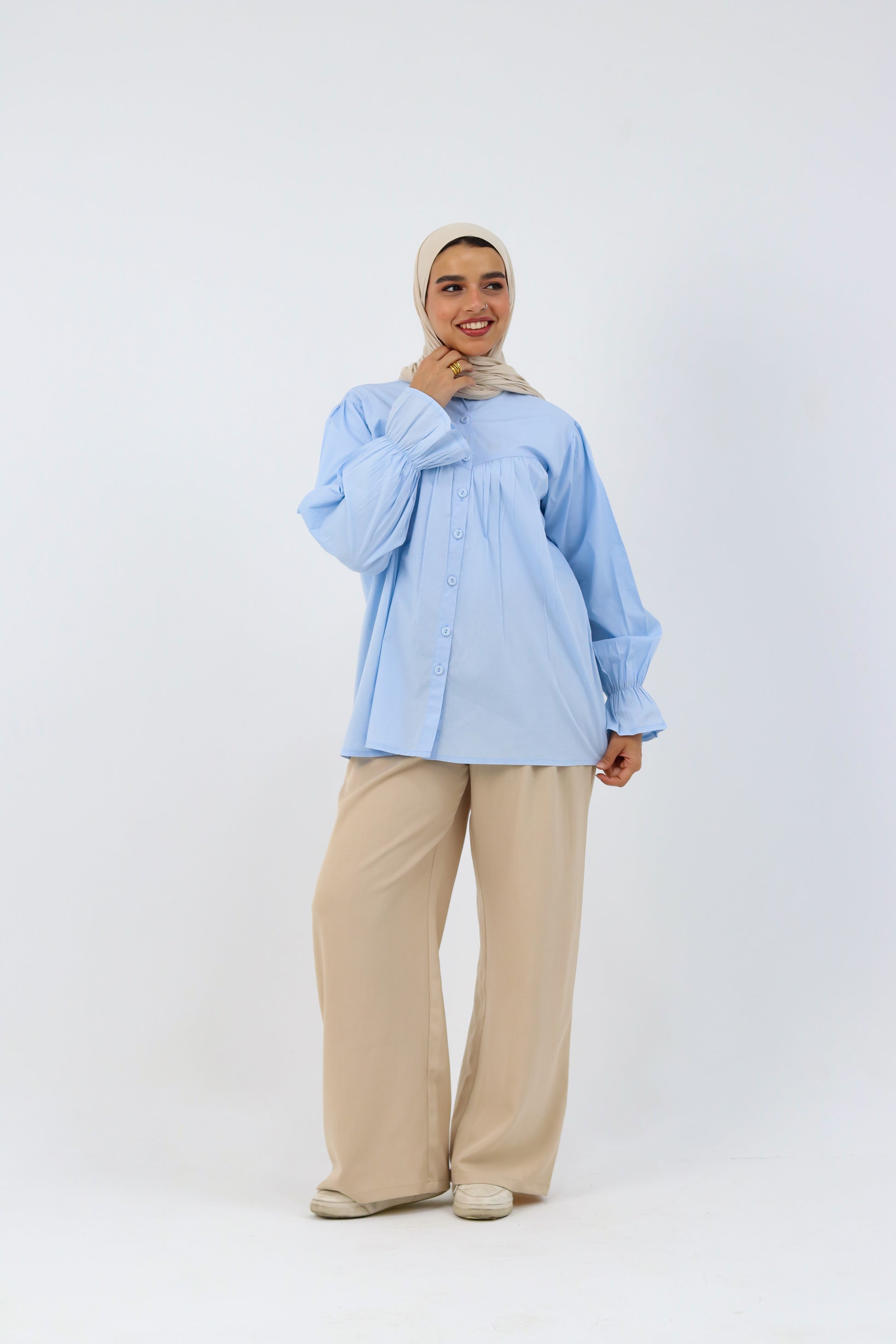 Baby blue THT GIRL Lady Blouse displayed on a hanger, showcasing its soft fabric and stylish design.