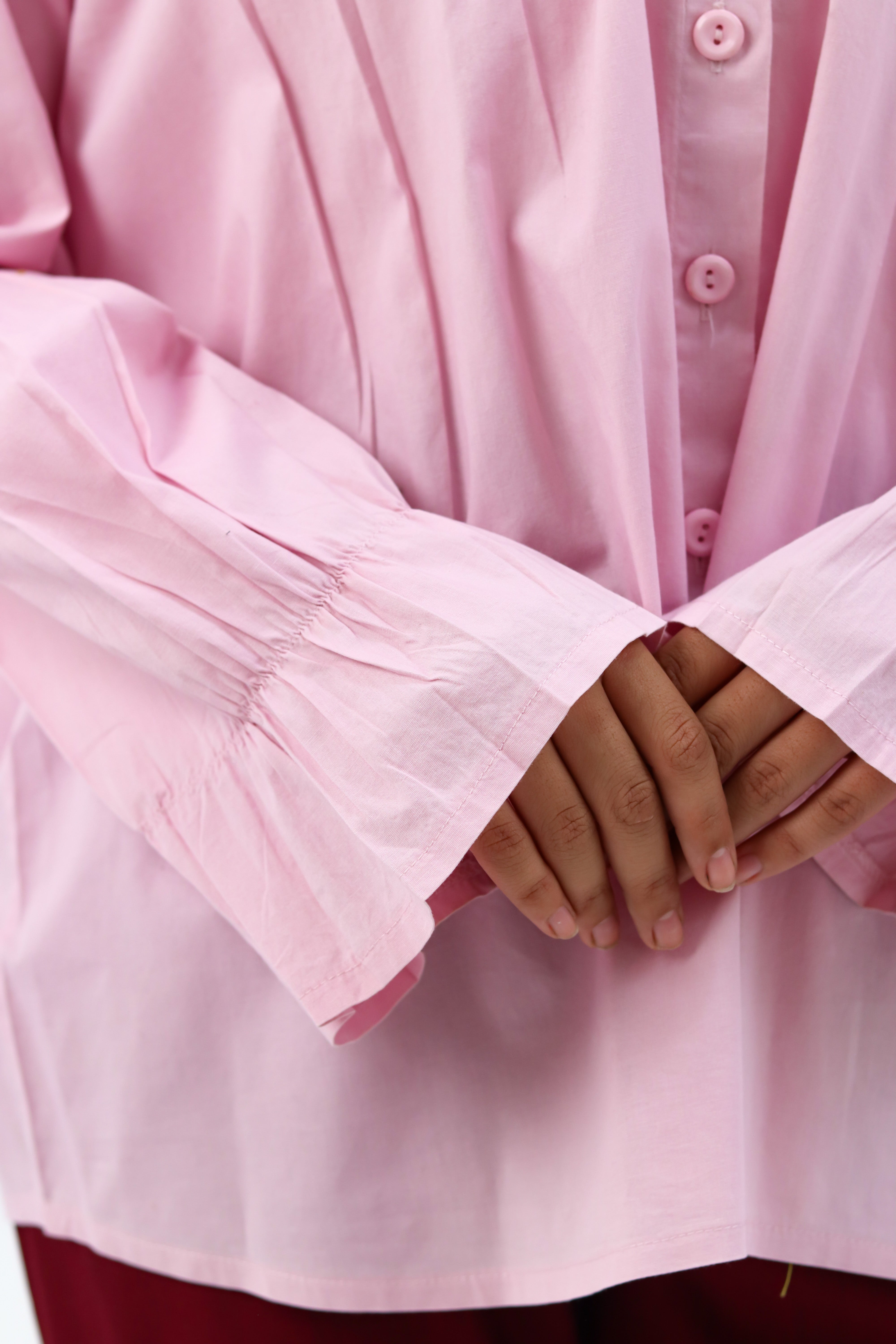 Baby pink THT GIRL Lady Blouse with long sleeves and elegant collar, displayed on a hanger.
