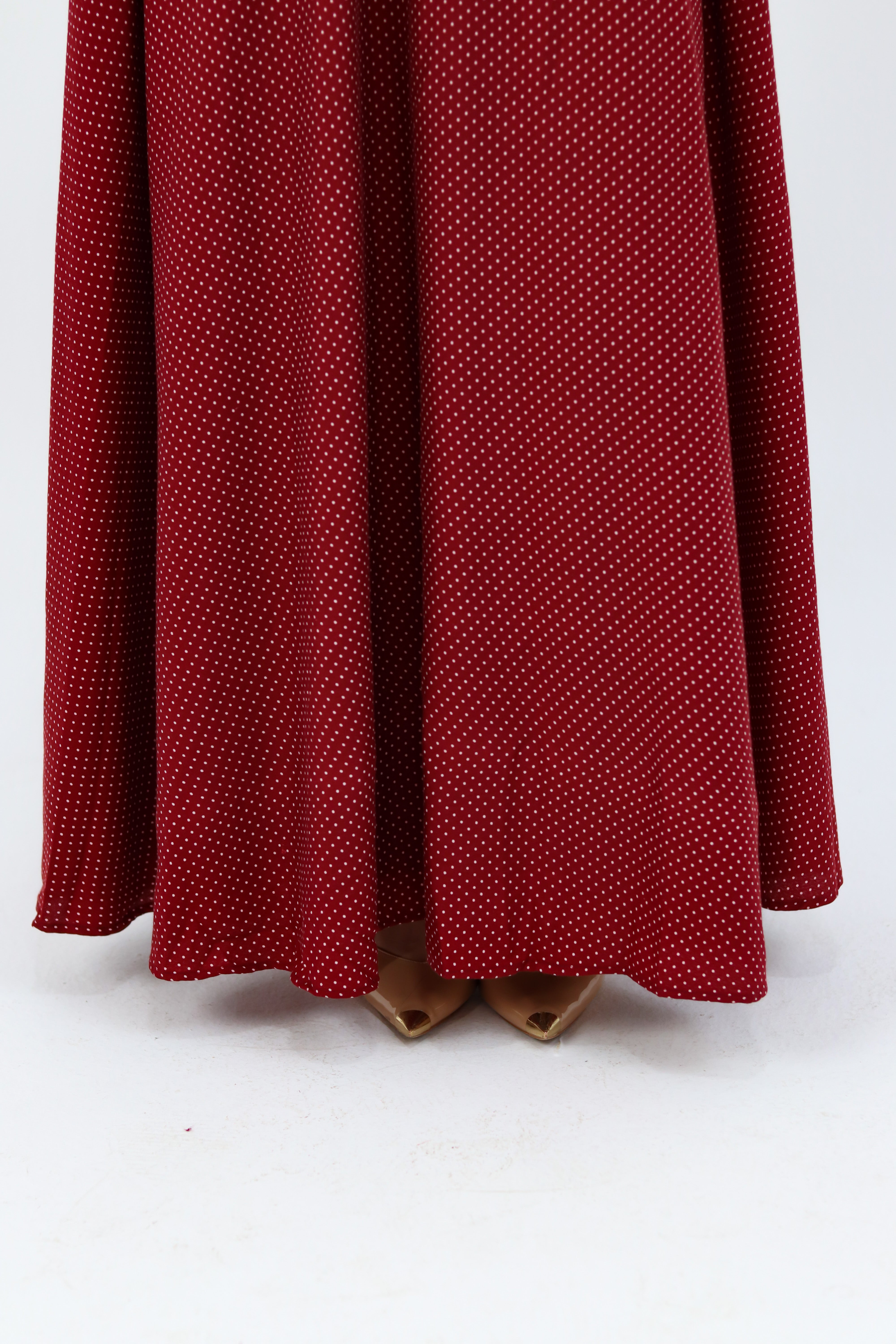 THT GIRL Burgundy Riviera skirt paired with a stylish blouse, showcasing a fashionable women's outfit in a well-lit setting.