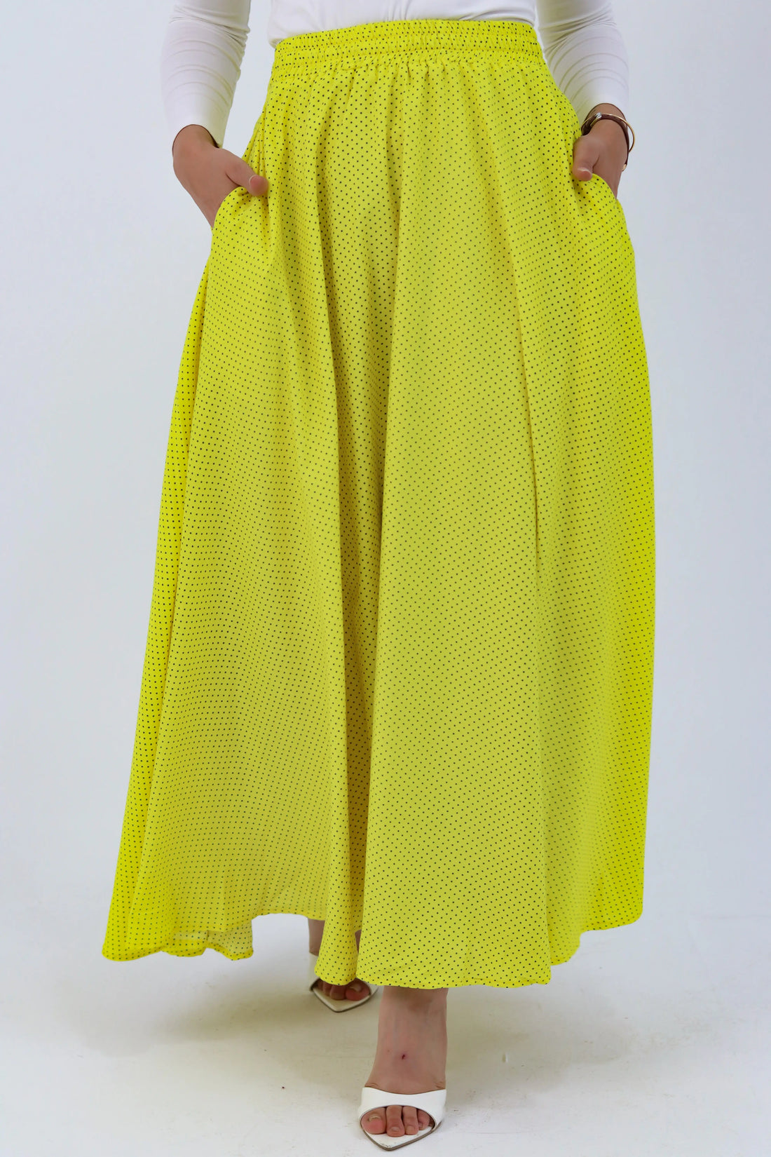 Yellow Riviera skirt from THT GIRL paired with a blouse, shown in a stylish outdoor setting.