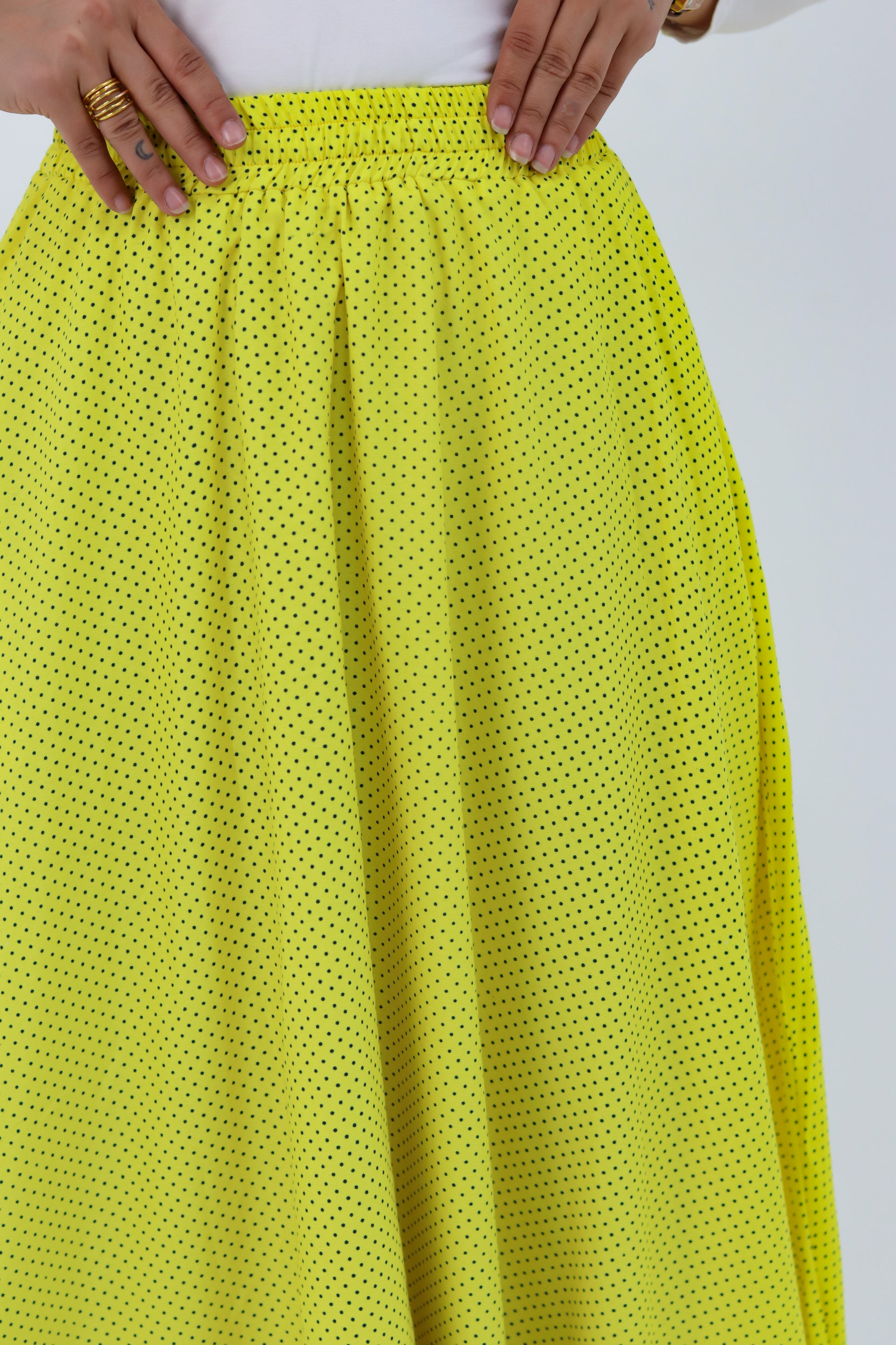 Yellow Riviera skirt styled with a THT GIRL blouse, featuring vibrant fabric and stylish design.