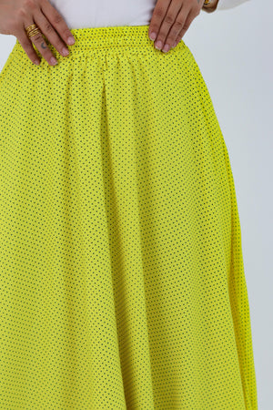 Yellow Riviera skirt styled with a THT GIRL blouse, featuring vibrant fabric and stylish design.
