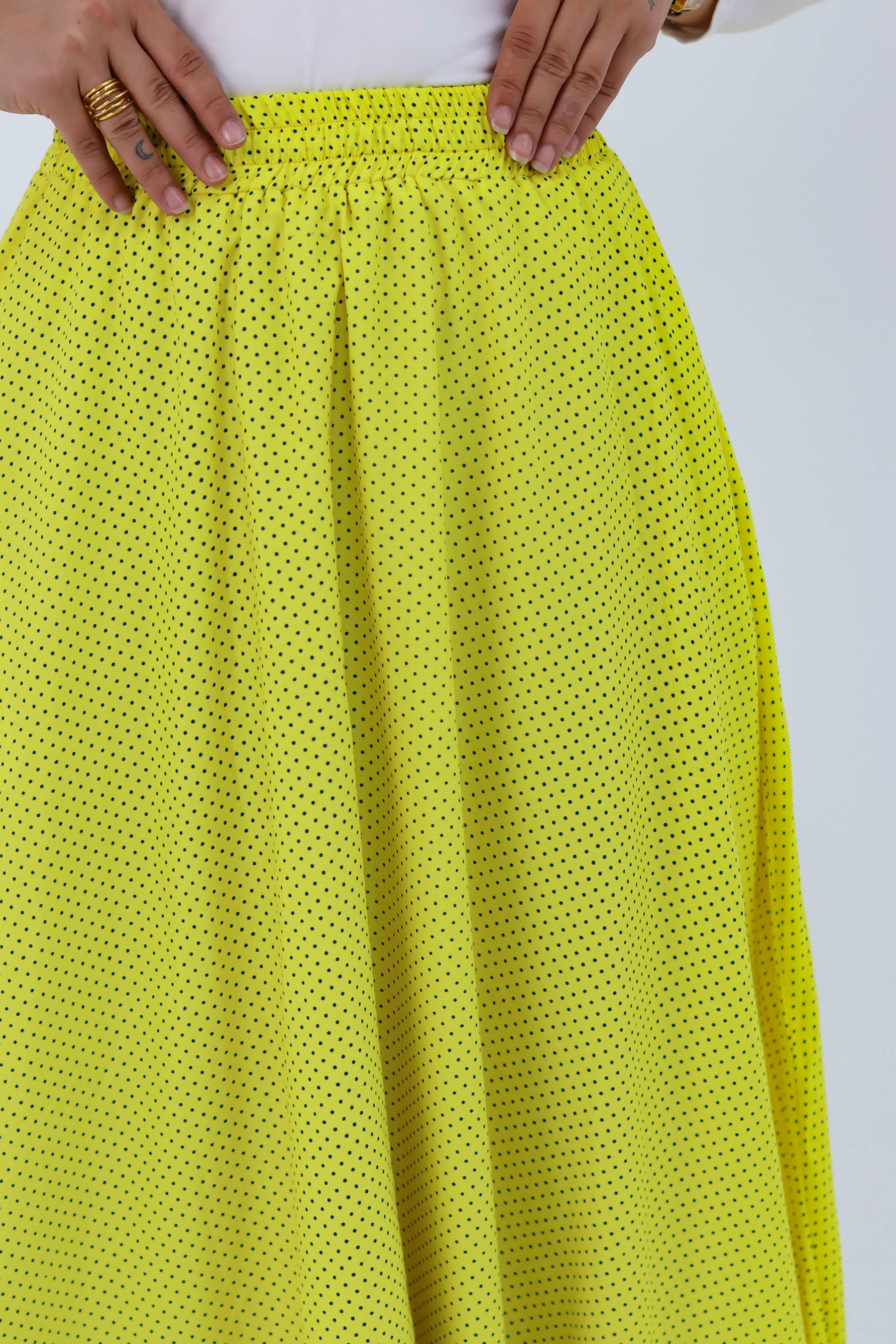Yellow Riviera skirt styled with a THT GIRL blouse, featuring vibrant fabric and stylish design.
