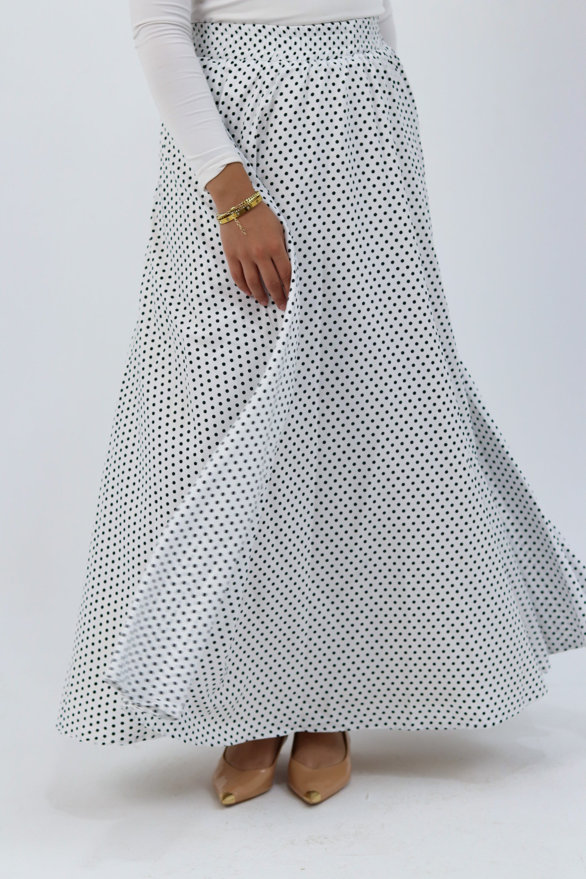 White blouse from THT GIRL featuring a Riviera skirt-style design, shown on a model.