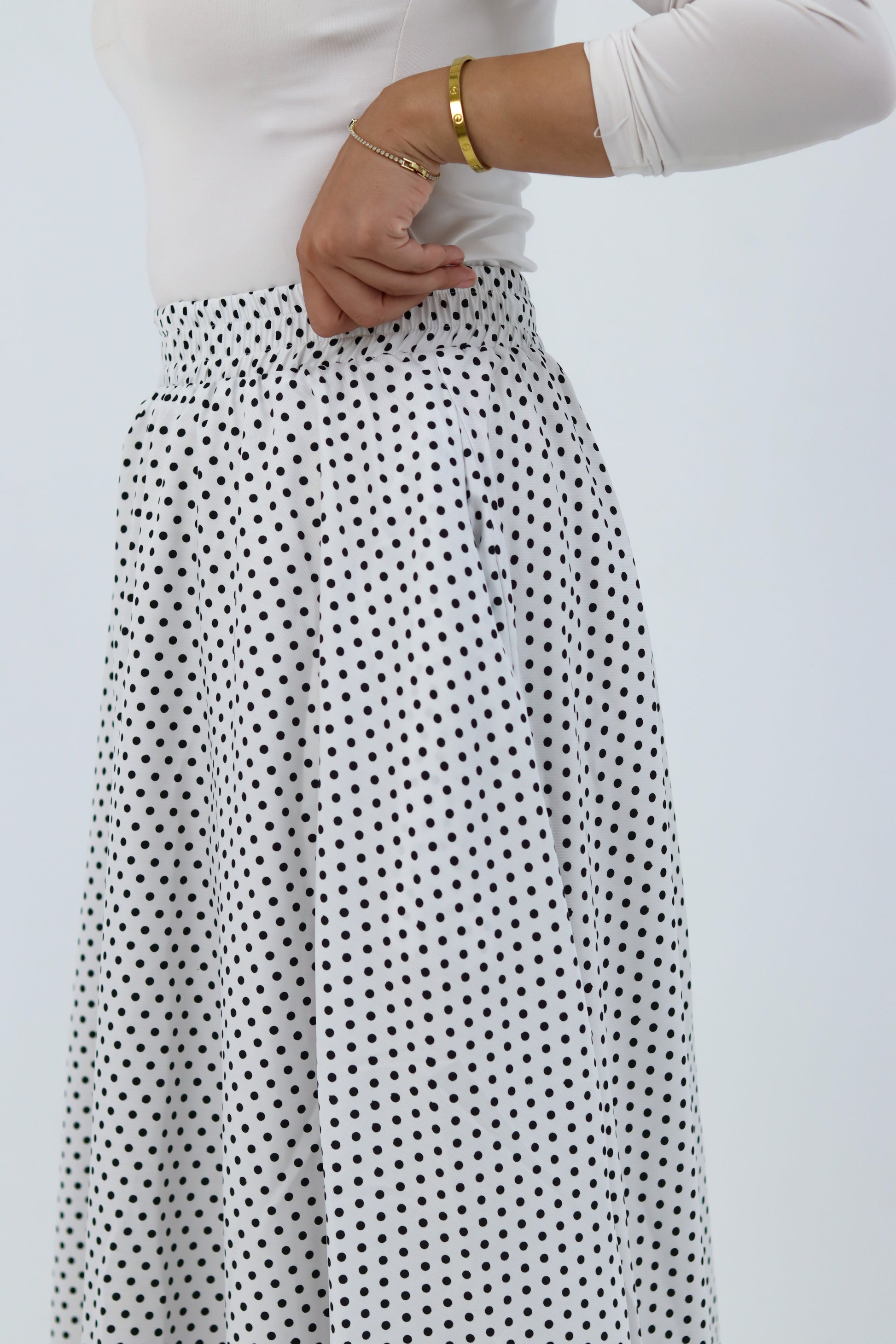 White Riviera blouse by THT GIRL displayed on a hanger, featuring a stylish, casual design with a collar and button details.
