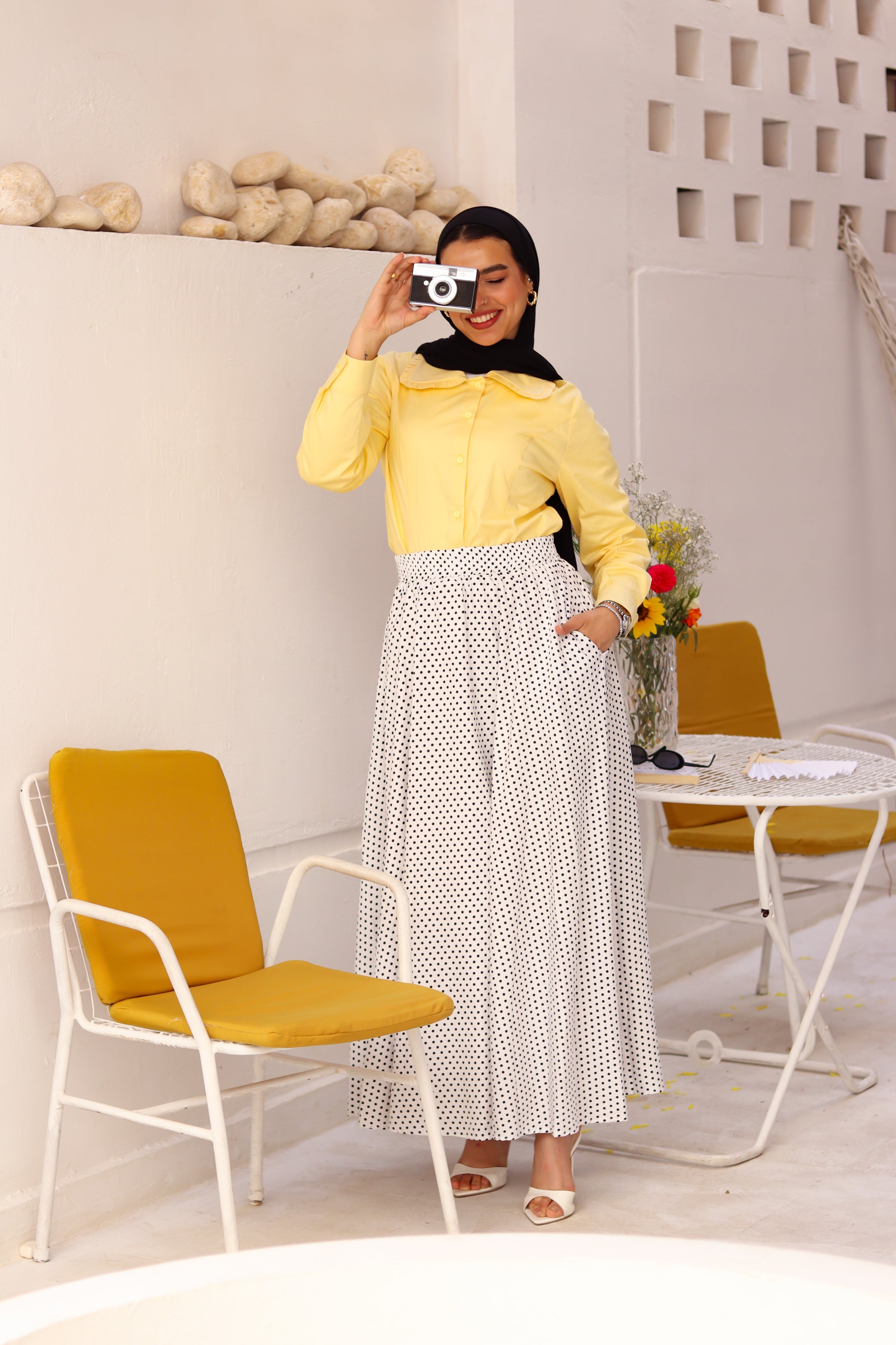 White Riviera blouse by THT GIRL displayed on a hanger with a close-up of the fabric and design details.