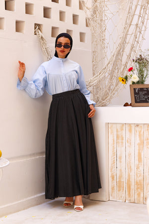 Baby blue THT GIRL Lady Blouse with long sleeves, lightweight fabric, and a relaxed fit, styled on a hanger.