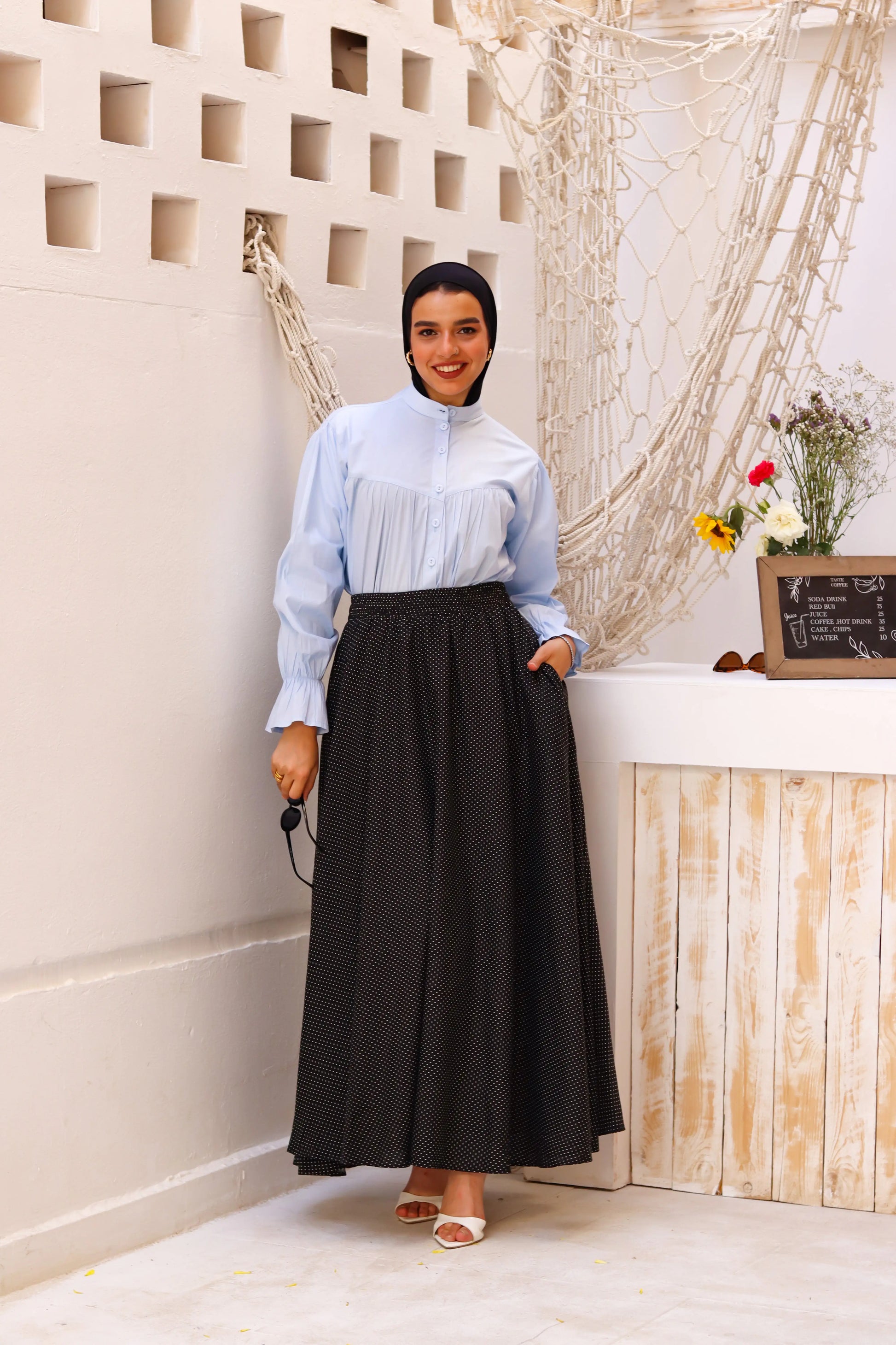 Black Riviera skirt paired with a THT Girl blouse, showcasing a stylish fashion ensemble.