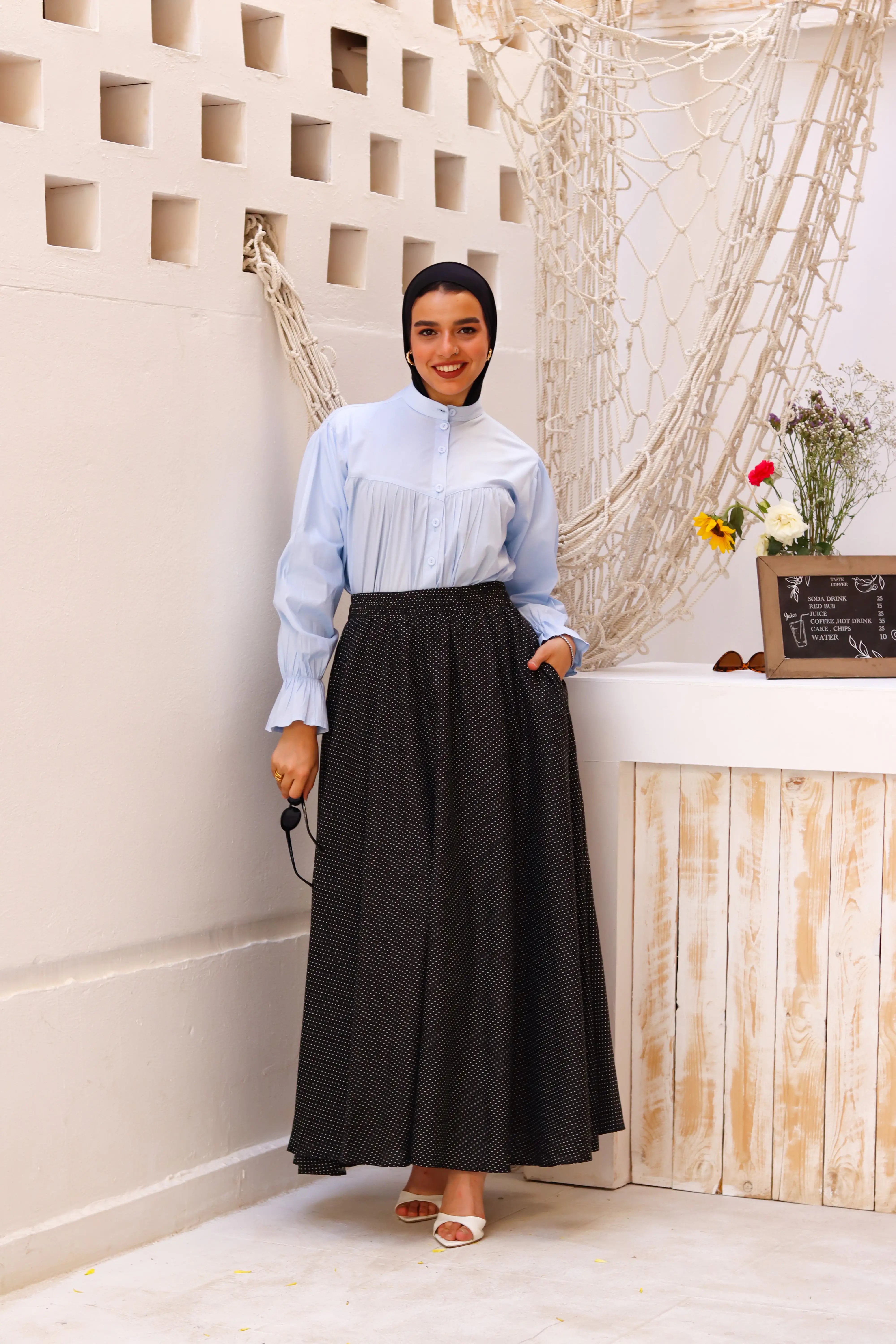 Black Riviera skirt paired with a THT Girl blouse, showcasing a stylish fashion ensemble.