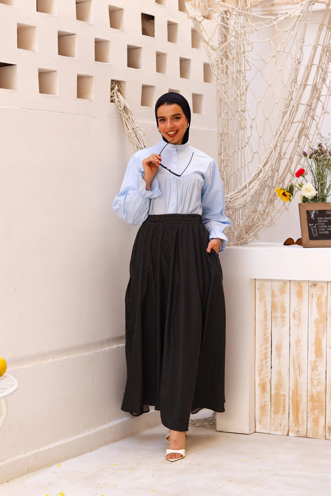 Black Riviera skirt paired with a THT Girl blouse, showcasing a stylish and elegant outfit with a focus on fabric and design details.
