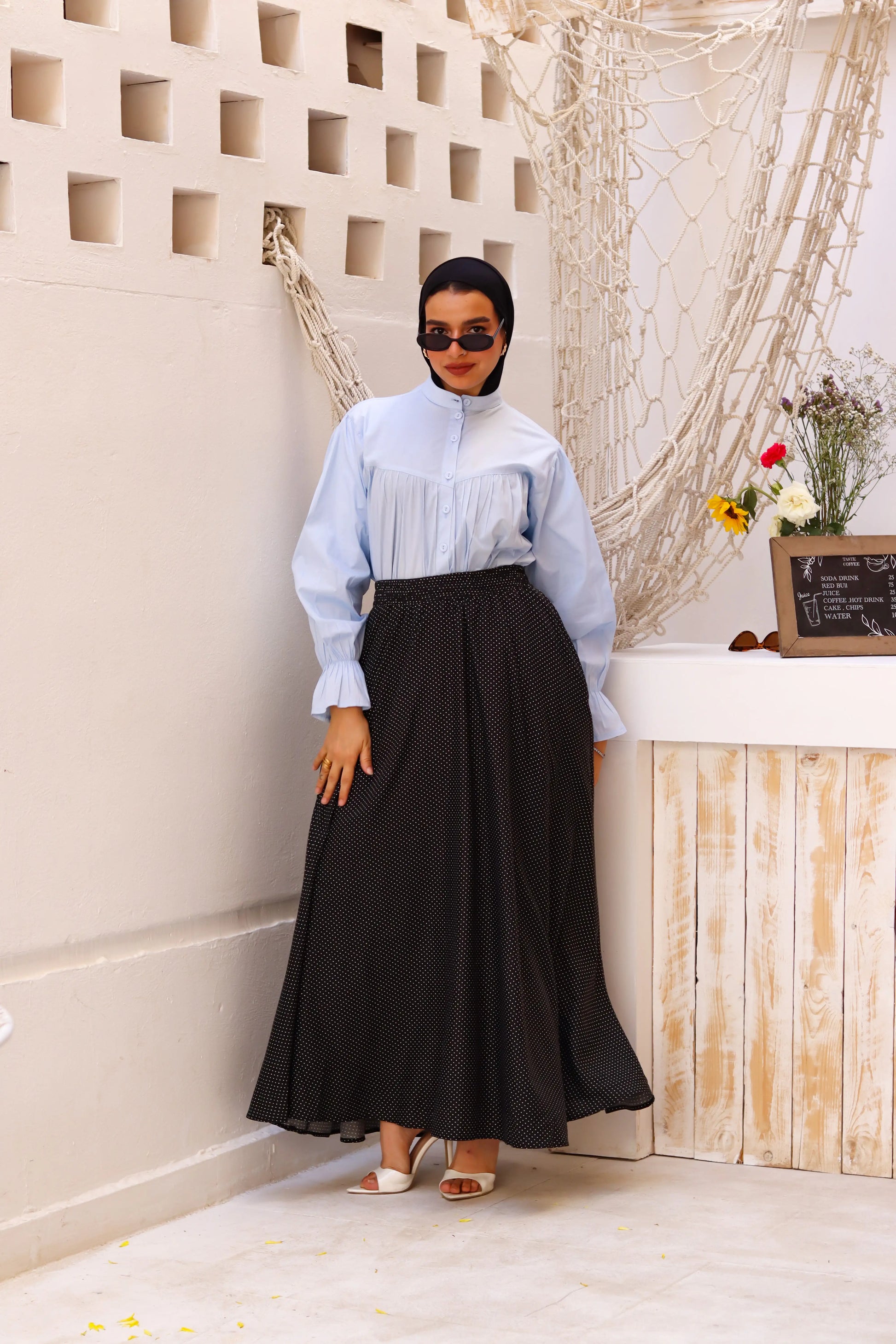 THT GIRL black Riviera skirt paired with a stylish blouse, showcasing a fashionable outfit for women.