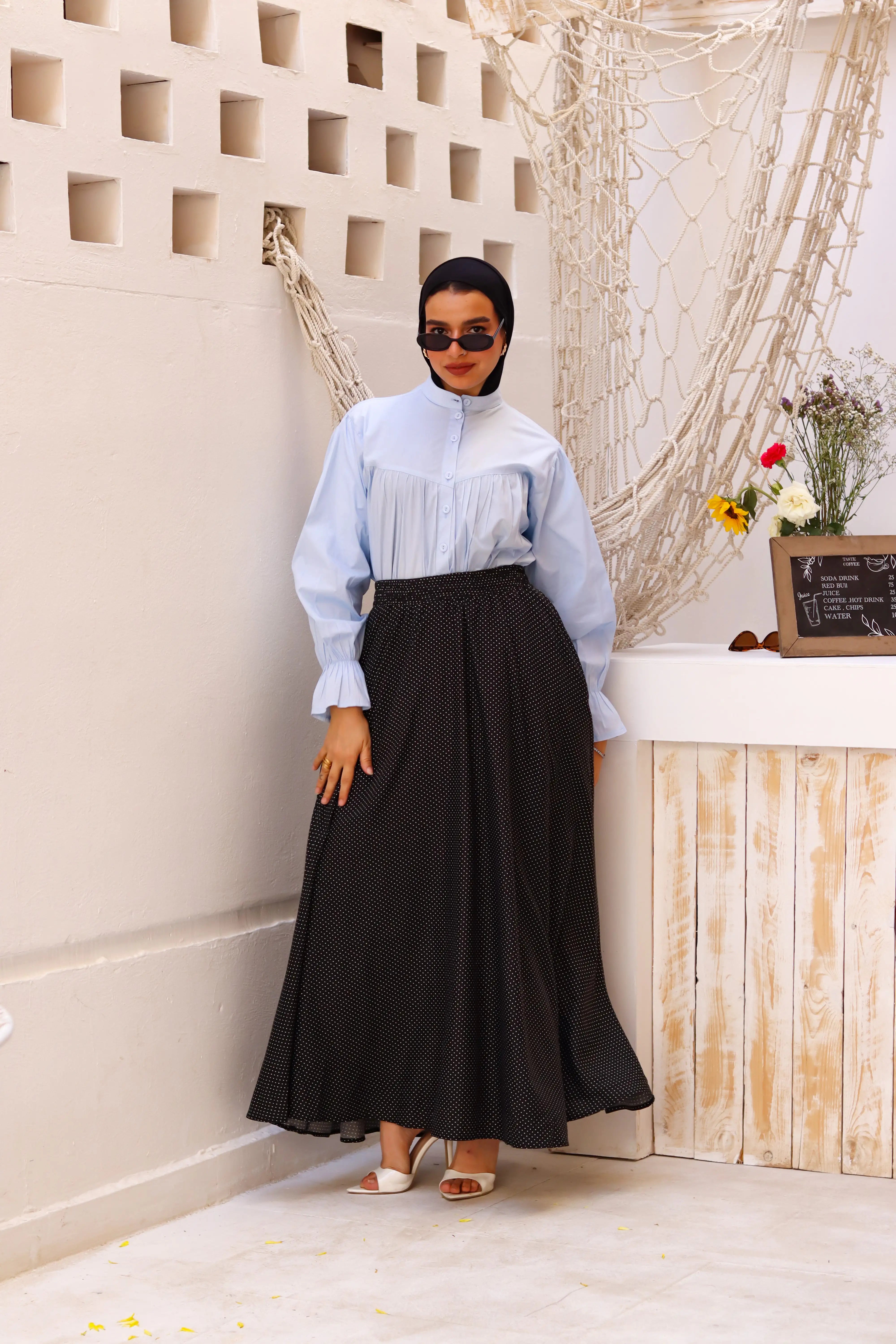 THT GIRL black Riviera skirt paired with a stylish blouse, showcasing a fashionable outfit for women.