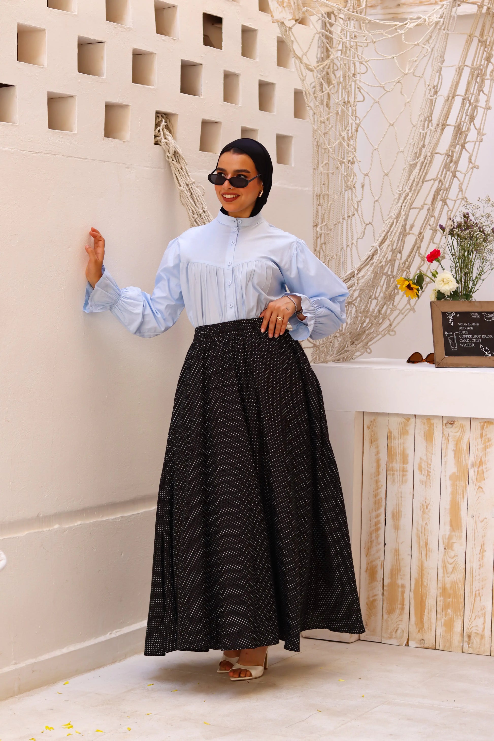 Black Riviera skirt paired with a THT GIRL blouse, showcasing a stylish and elegant outfit.