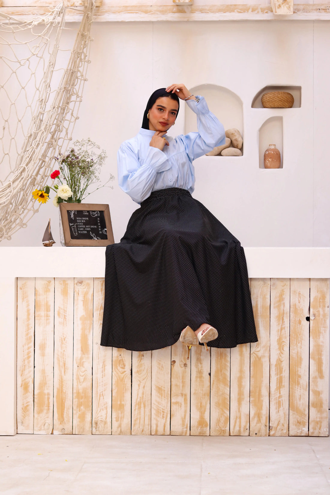 Black Riviera skirt paired with a THT Girl blouse, showcasing a stylish and elegant outfit with a focus on fabric and design details.