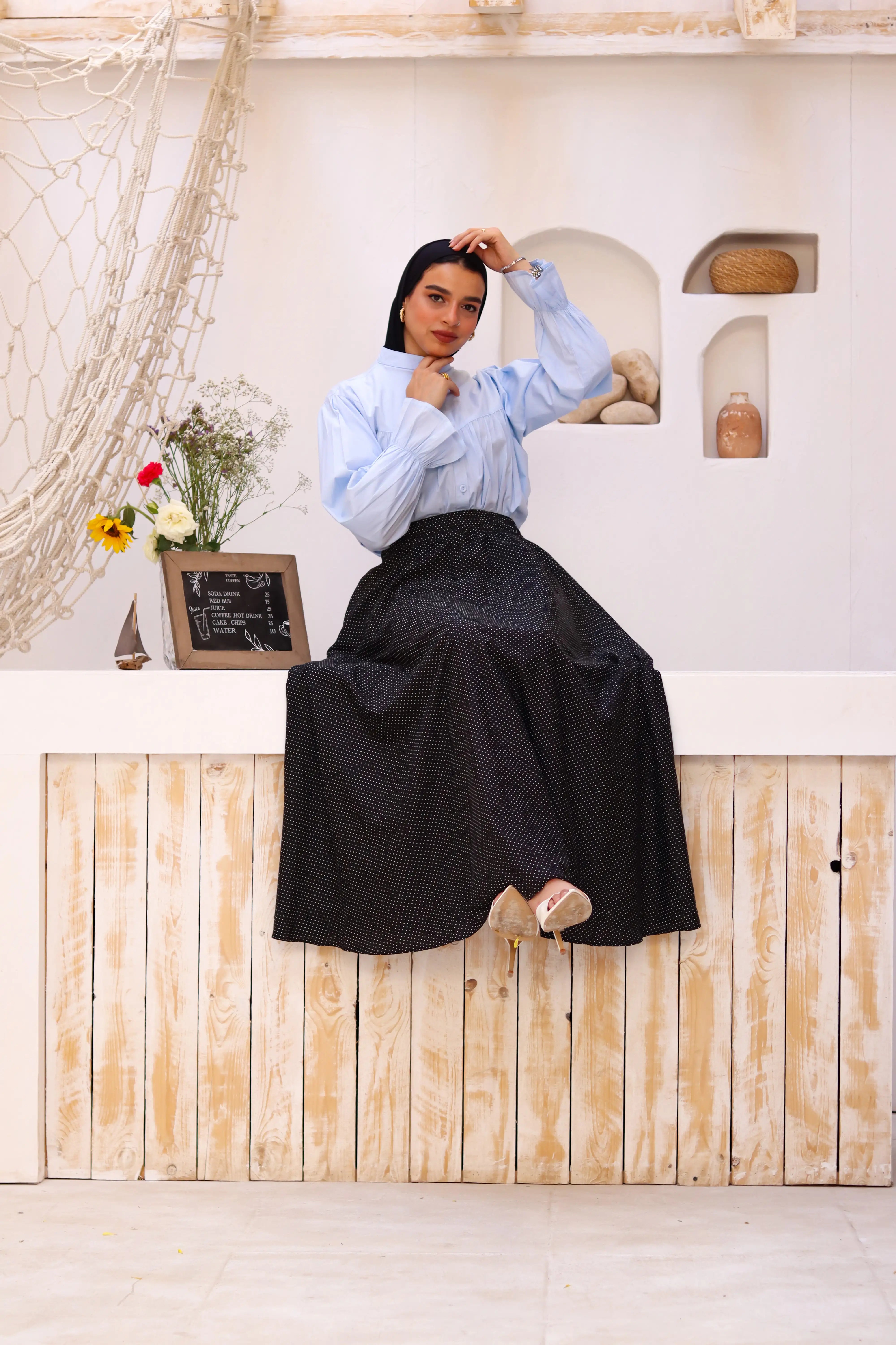 Black Riviera skirt paired with a THT GIRL blouse, showing a stylish outfit on a model.