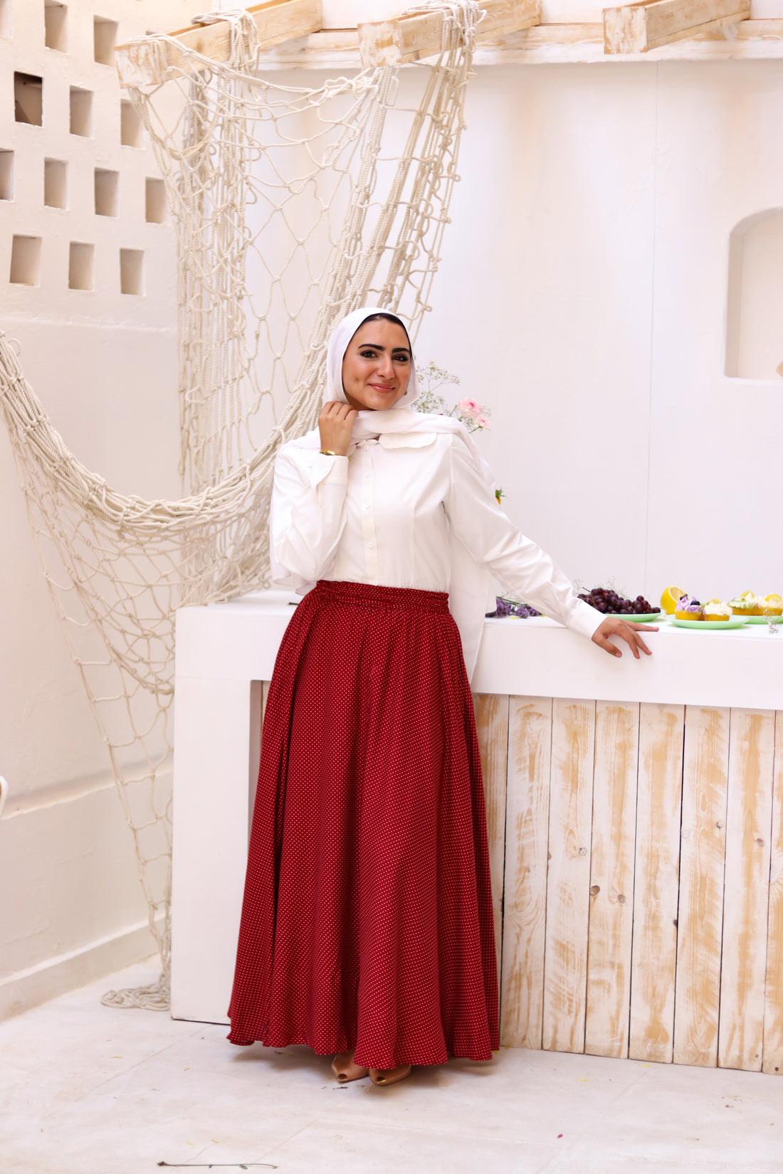 THT Girl Riviera burgundy skirt paired with a stylish blouse, shown in a well-lit fashion image.