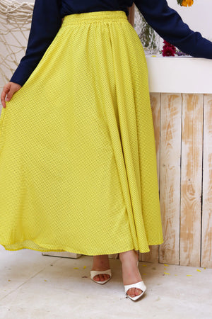 Yellow Riviera skirt paired with a THT GIRL blouse, shown in a stylish outfit featuring the vibrant yellow skirt.