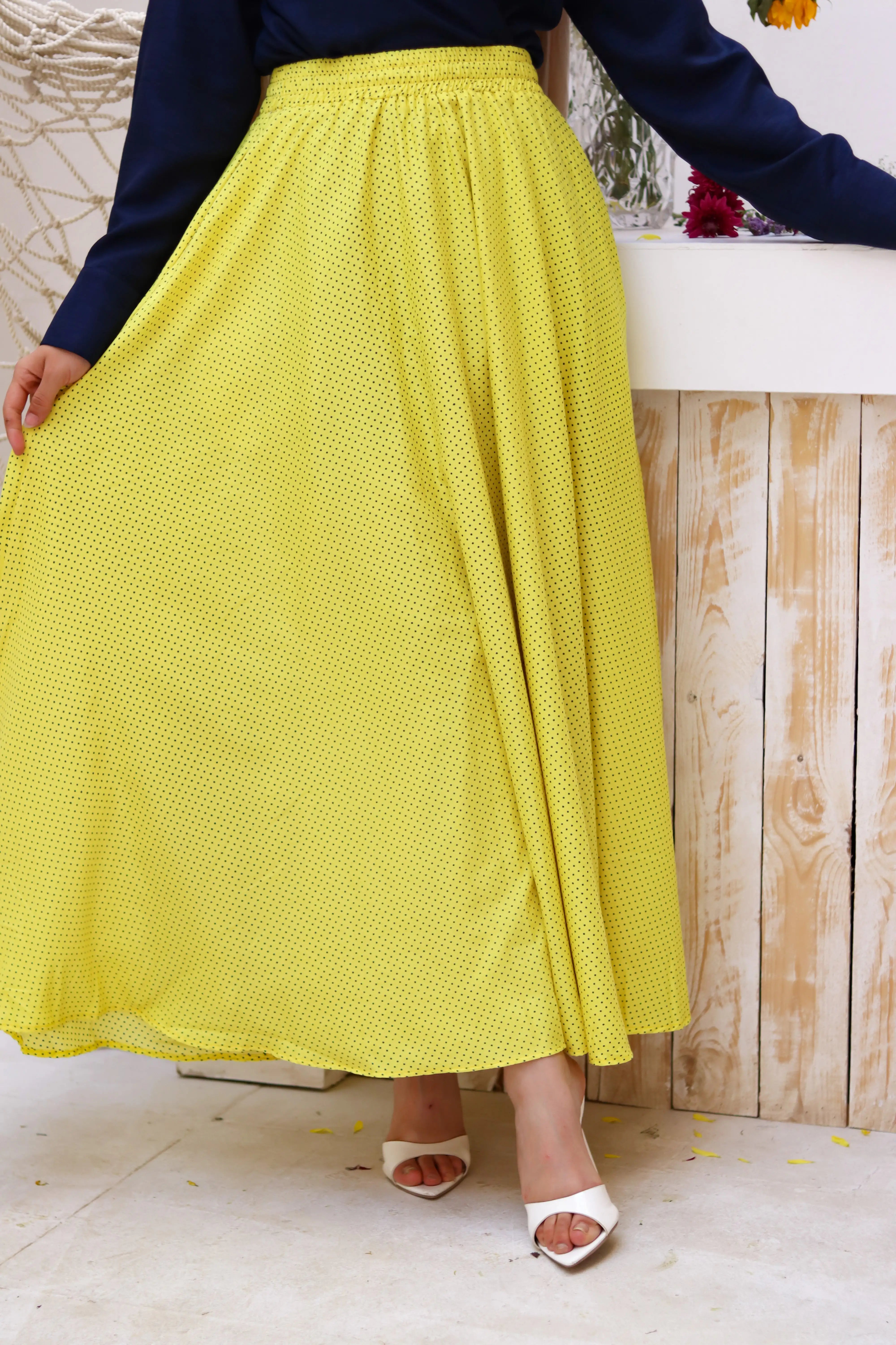 Yellow Riviera skirt paired with a THT GIRL blouse, shown in a stylish outfit featuring the vibrant yellow skirt.