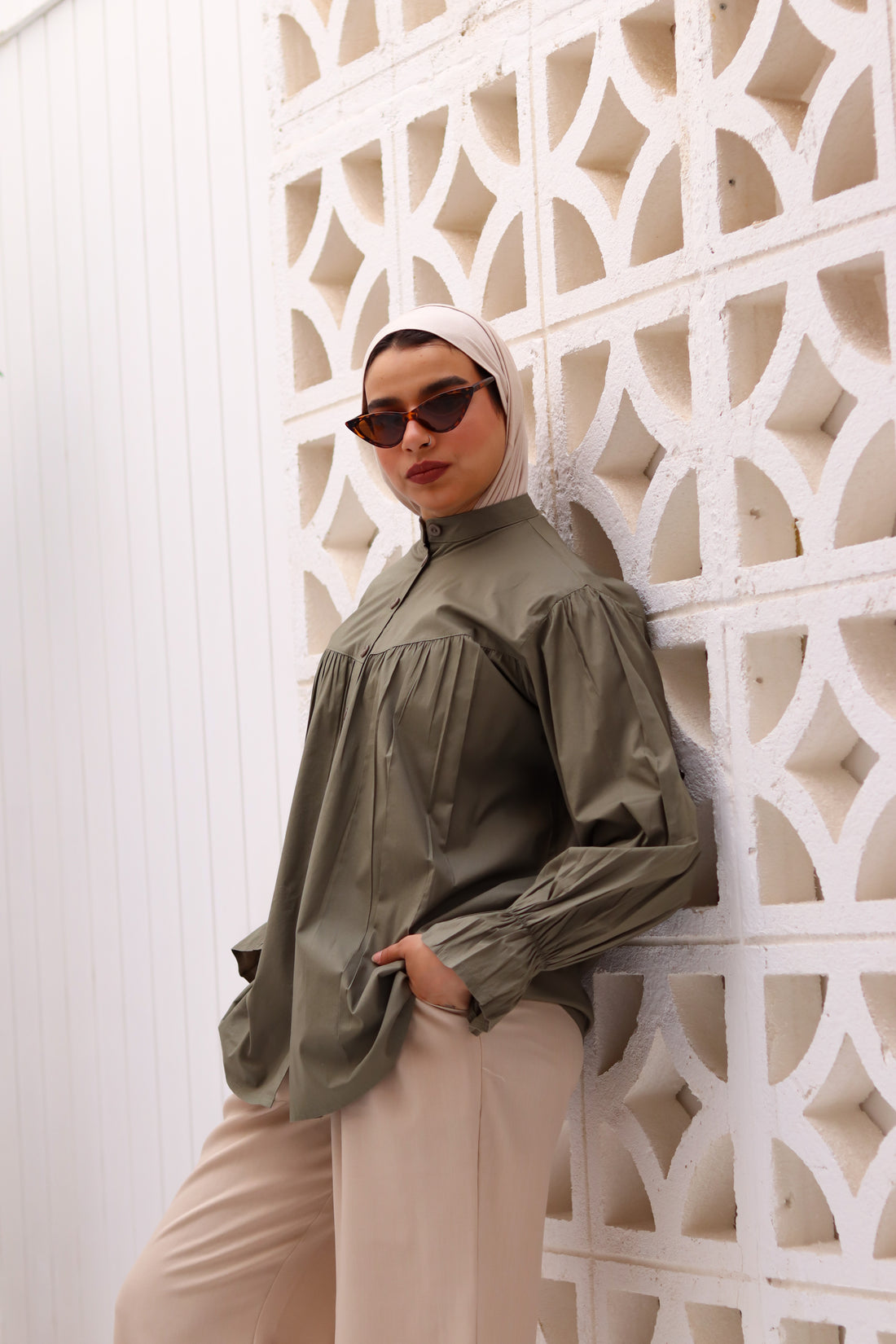 Olive THT GIRL Lady Blouse displayed on a hanger, featuring a stylish, lightweight design with a V-neck and long sleeves.