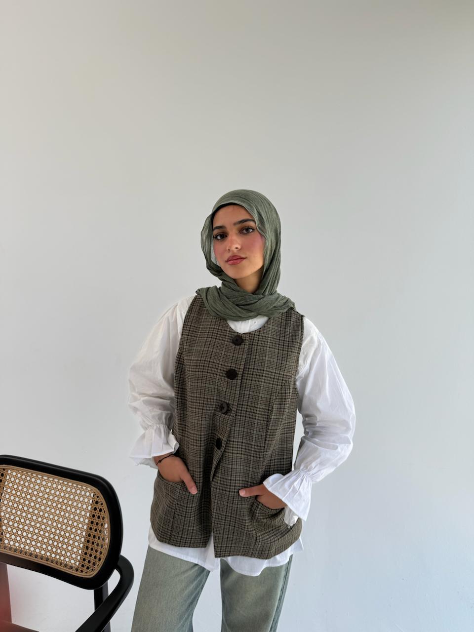 THT GIRL London Vest displayed on a hanger, featuring a stylish, sleeveless design in a neutral fabric.