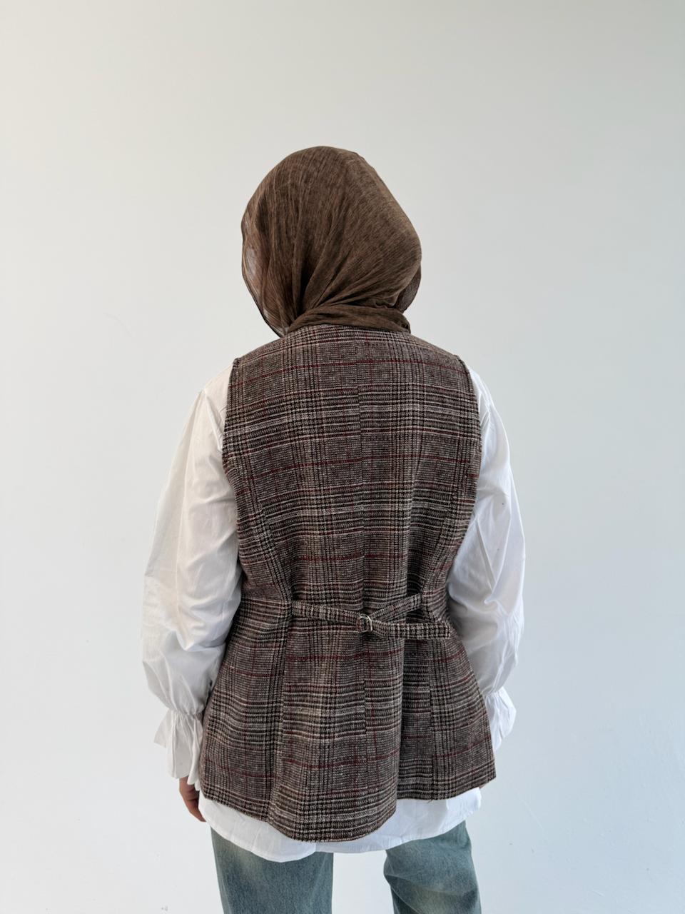THT GIRL London vest, stylish sleeveless outerwear in neutral color, displayed on a hanger.