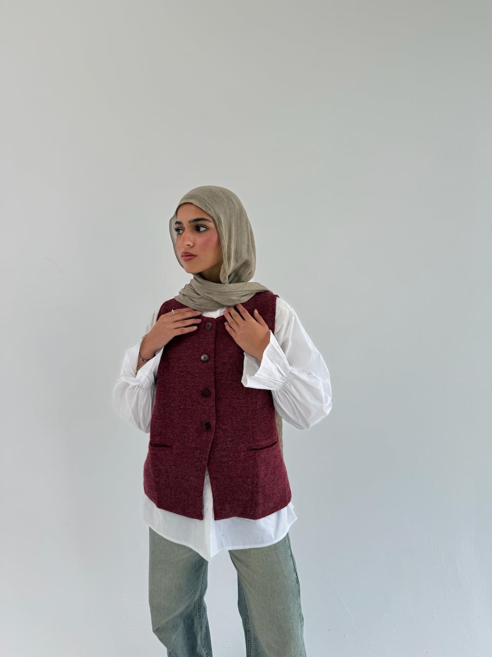 THT GIRL London vest displayed on a hanger, featuring a sleek, stylish design suitable for casual or layered outfits.